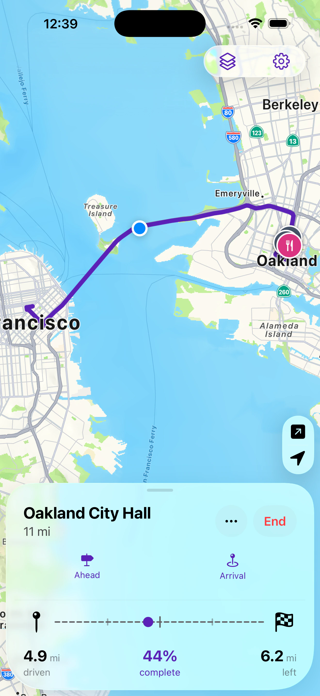 Route overview mid-drive: 44 percent complete, 4.9 miles driven, 6.2 miles left, with pinned parking and food near the destination.